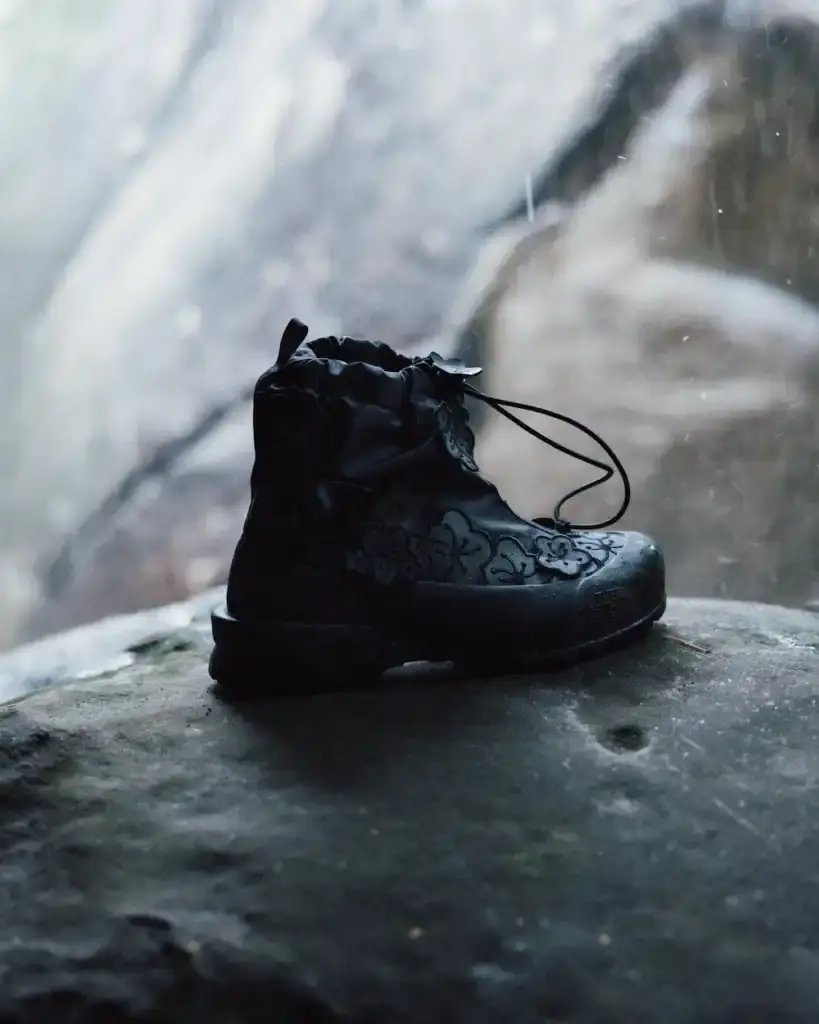 Cecile Bahnsen Models wearing The North Face x Cecile Bahnsen collection climbing on rocks in Fontainebleau natural setting. (image 6 of 6)
