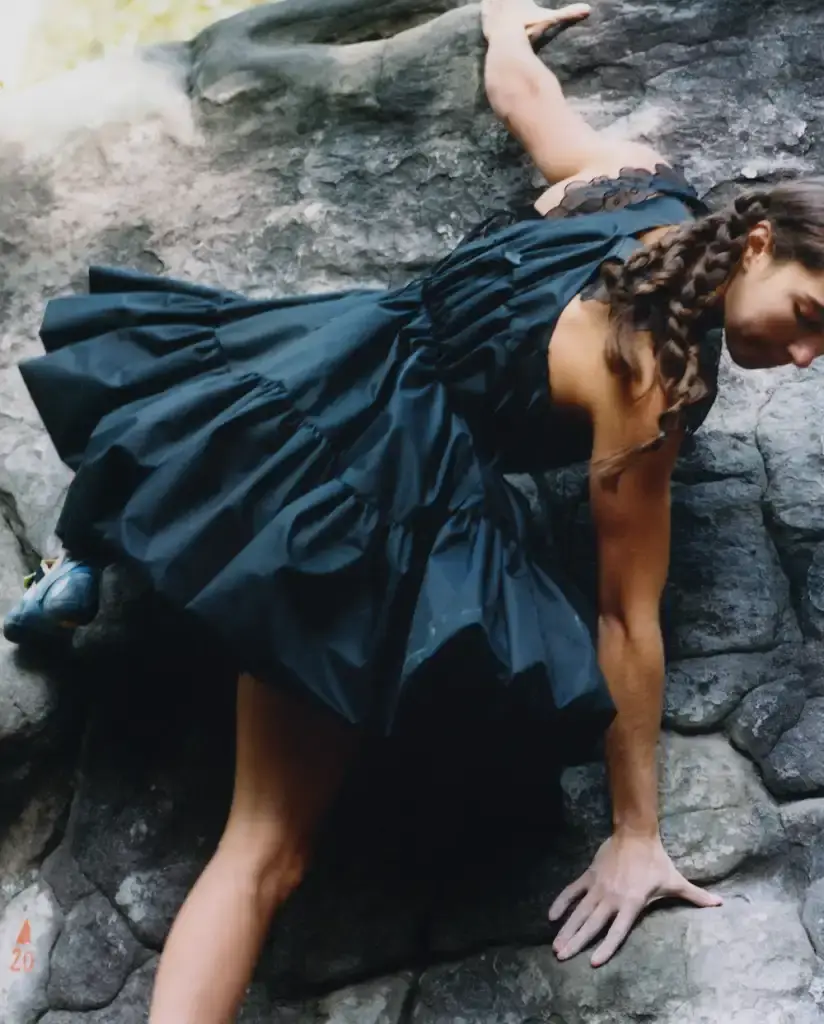 Cecile Bahnsen Models wearing The North Face x Cecile Bahnsen collection climbing on rocks in Fontainebleau natural setting. (image 5 of 6)