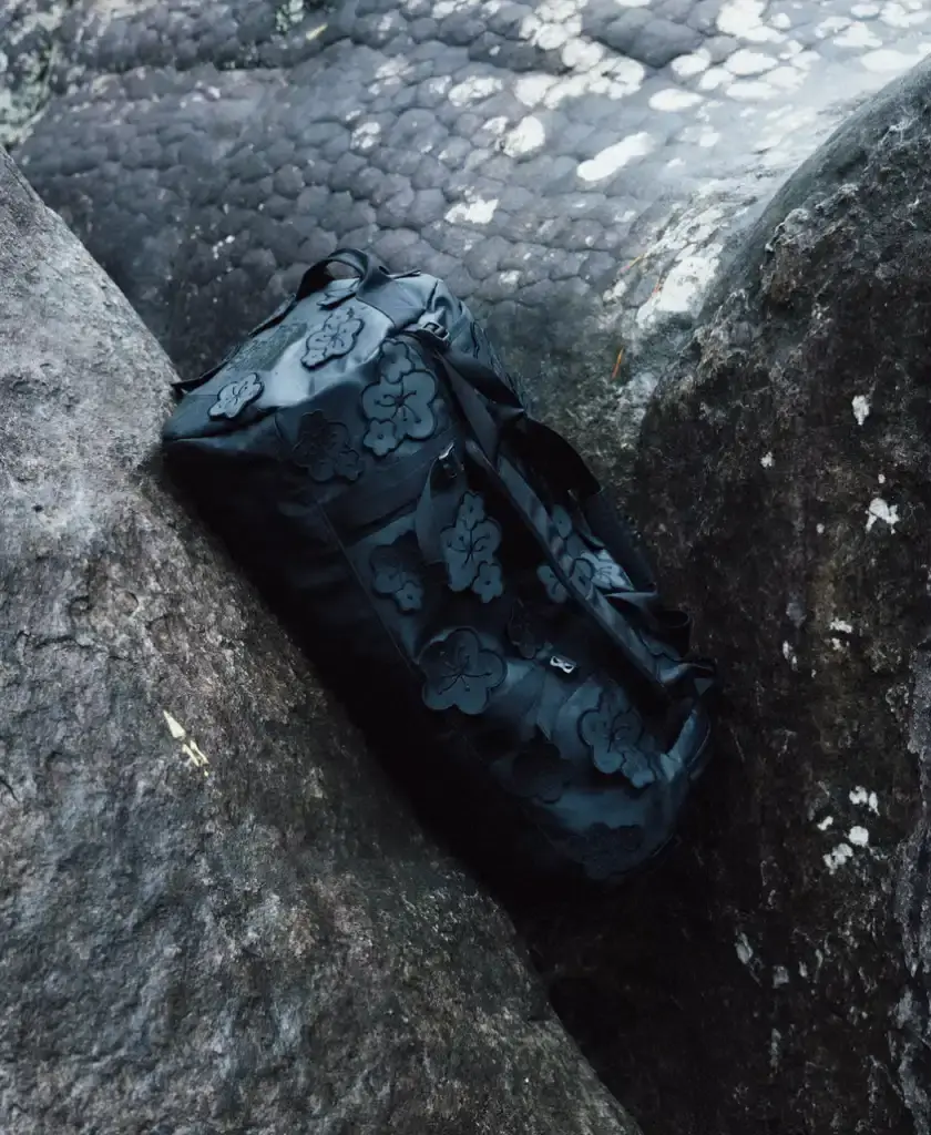 Cecile Bahnsen Models wearing The North Face x Cecile Bahnsen collection climbing on rocks in Fontainebleau natural setting. (image 4 of 6)