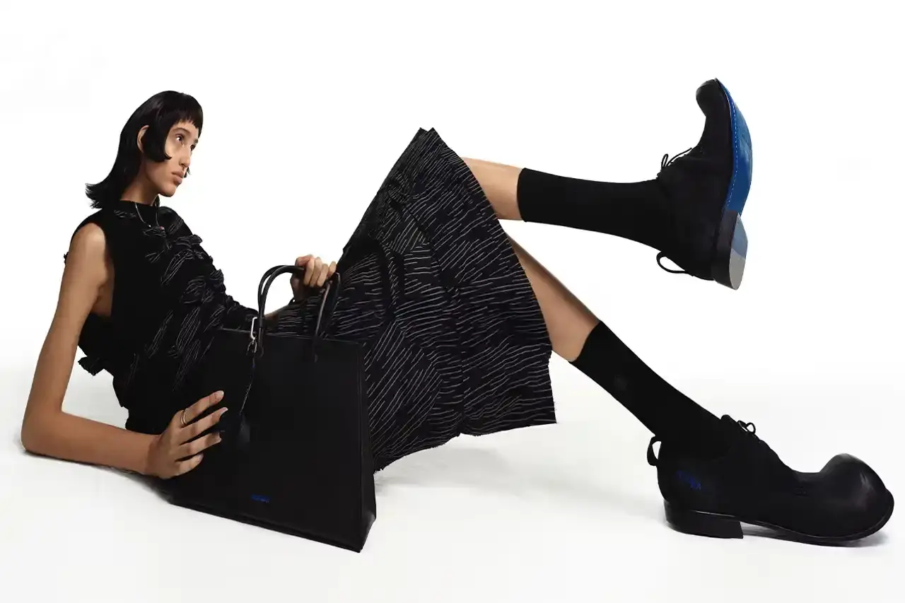 ADER ERROR A fashion collection lookbook featuring minimalist designs that blend architectural silhouettes with subtle, intricate details. Garments in muted tones showcase complex knot work, layered textures, and geometric patterns that explore themes of memory and connection. Models wear carefully constructed outerwear, skirt sets, and tops that challenge traditional fashion boundaries.