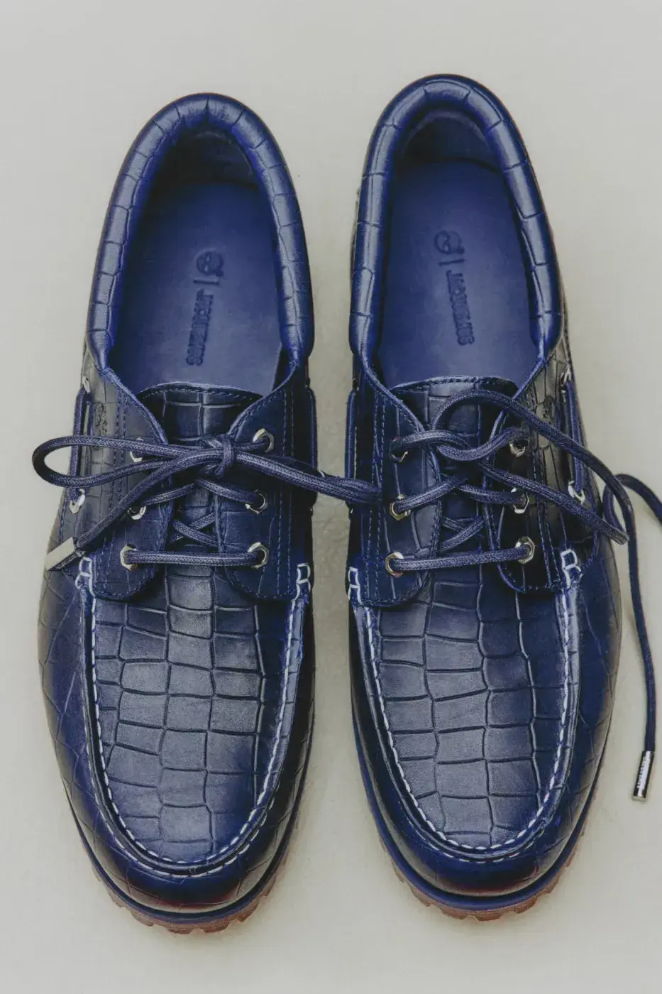 TIMBERLAND X JACQUEMUS BOAT SHOE IN CROC-EMBOSSED LEATHER image of Timberland x Jacquemus Authentic Boat Shoe in Brown Croc and Navy Croc, both made from crocodile-embossed leather with a rubber outsole. (image 9 of 9)