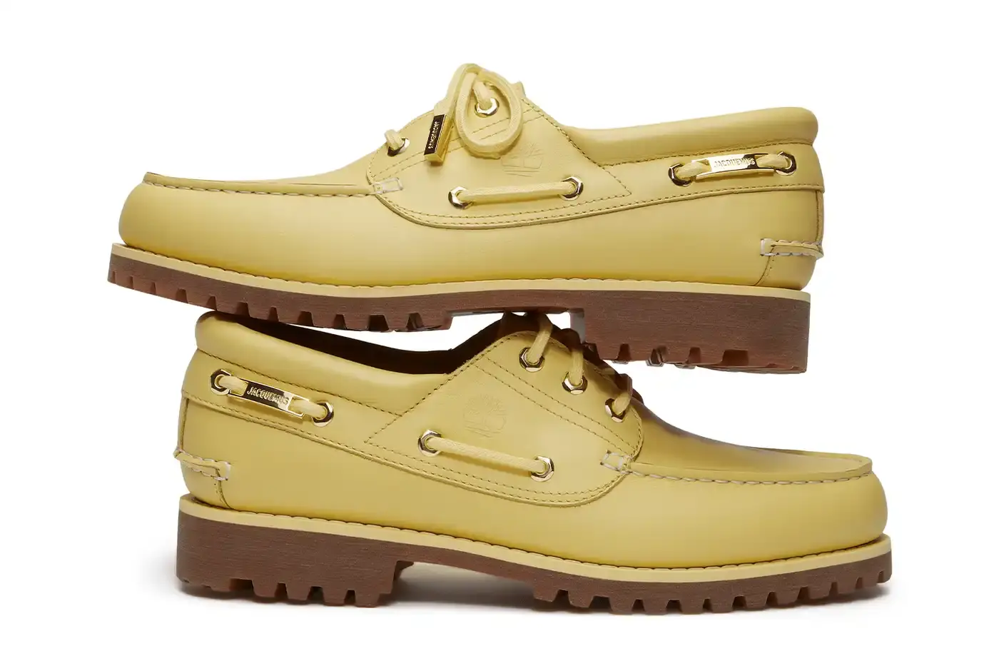 TIMBERLAND X JACQUEMUS COLLABORATION TRANSFORMS CLASSIC BOAT SHOE pictures of "La Bateau," a collaborative shoe between Timberland and Jacquemus. The design refreshes Timberland's classic 3-Eye Lug Boat Shoe with a bright yellow color and gold metal accents, including unique lace eyelets. The premium leather shoe will be available at Jacquemus stores, Timberland's Tokyo flagship, and online for £225 GBP ($250 USD).