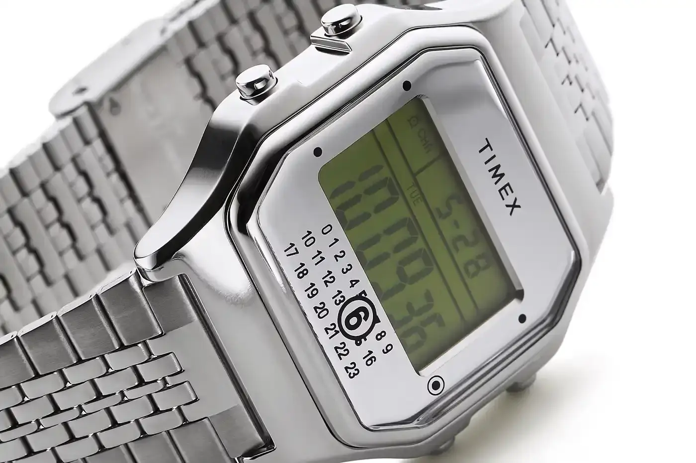TIMEX X MM6 MAISON MARGIELA LAUNCH T80 DIGITAL WATCH COLLECTION Two Timex x MM6 Maison Margiela T80 digital watches displayed on a light background - a wristwatch and ring watch in mirror-finish stainless steel (image 6 of 7)