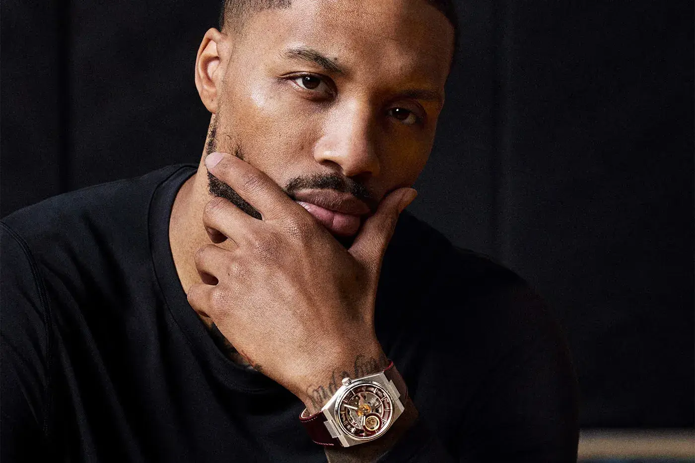 TISSOT RELEASES THE PRX SKELETON DAMIAN LILLARD EDITION Tissot PRX Skeleton Damian Lillard Special Edition, a 44mm steel watch with an openworked dial, burgundy straps and a gold-colored seconds hand.