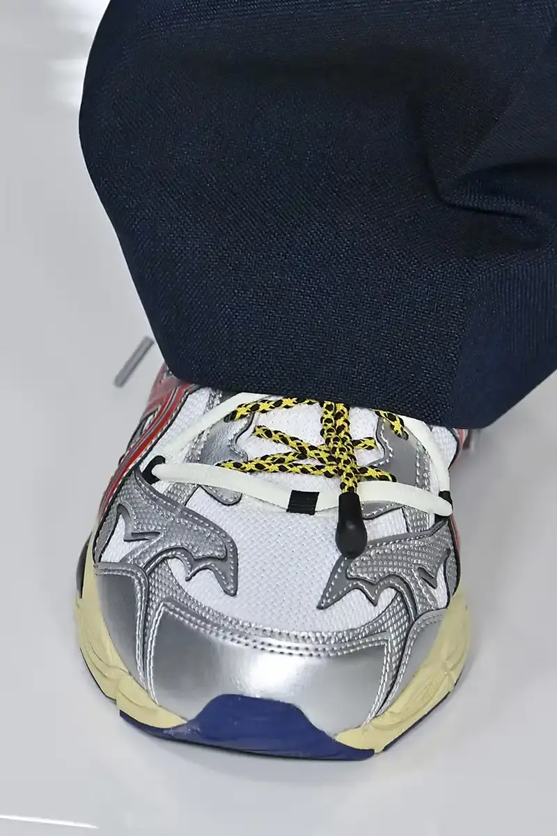 Victor Virgile/Gamma-Rapho/Getty Images TOGA x ASICS collaborative sneakers featuring decorative appliqué, dual lacing system, and ornamental hardware in gray, silver/red, and earth tone colorways. (image 5 of 5)