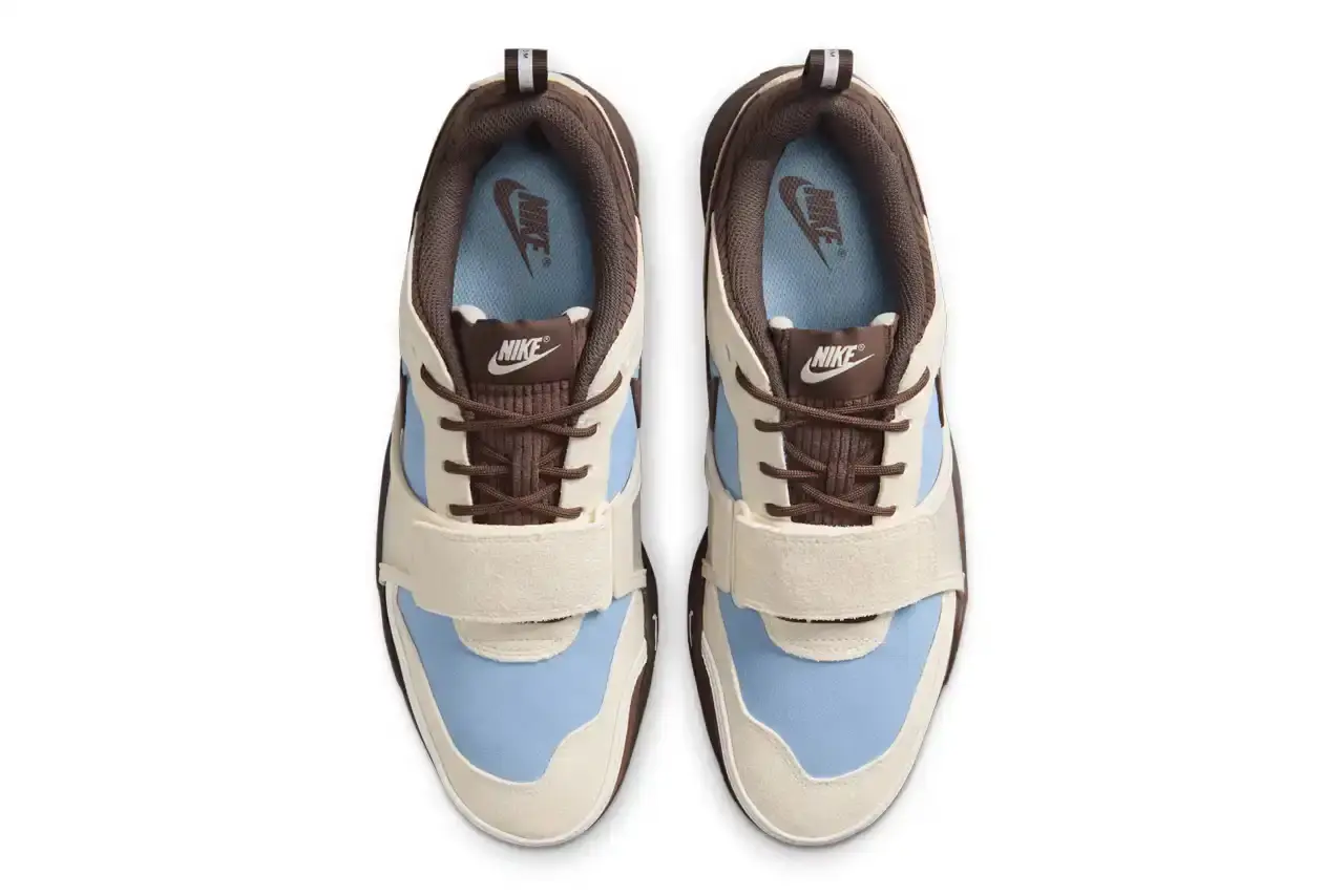 NIKE UNVEILS TRAVIS SCOTT'S ZOOM FIELD JAXX IN "LECHE BLUE" Image of the upcoming release of the Travis Scott x Nike Zoom Field Jaxx sneaker in "Leche Blue" colorway. It details the shoe's design inspiration from the Zoom Spiridon runner and Land Shark baseball cleat, describes the blue and brown color scheme, mentions the $170 price point, and notes the May 16 release date through Nike SNKRS and select retailers. (image 4 of 7)