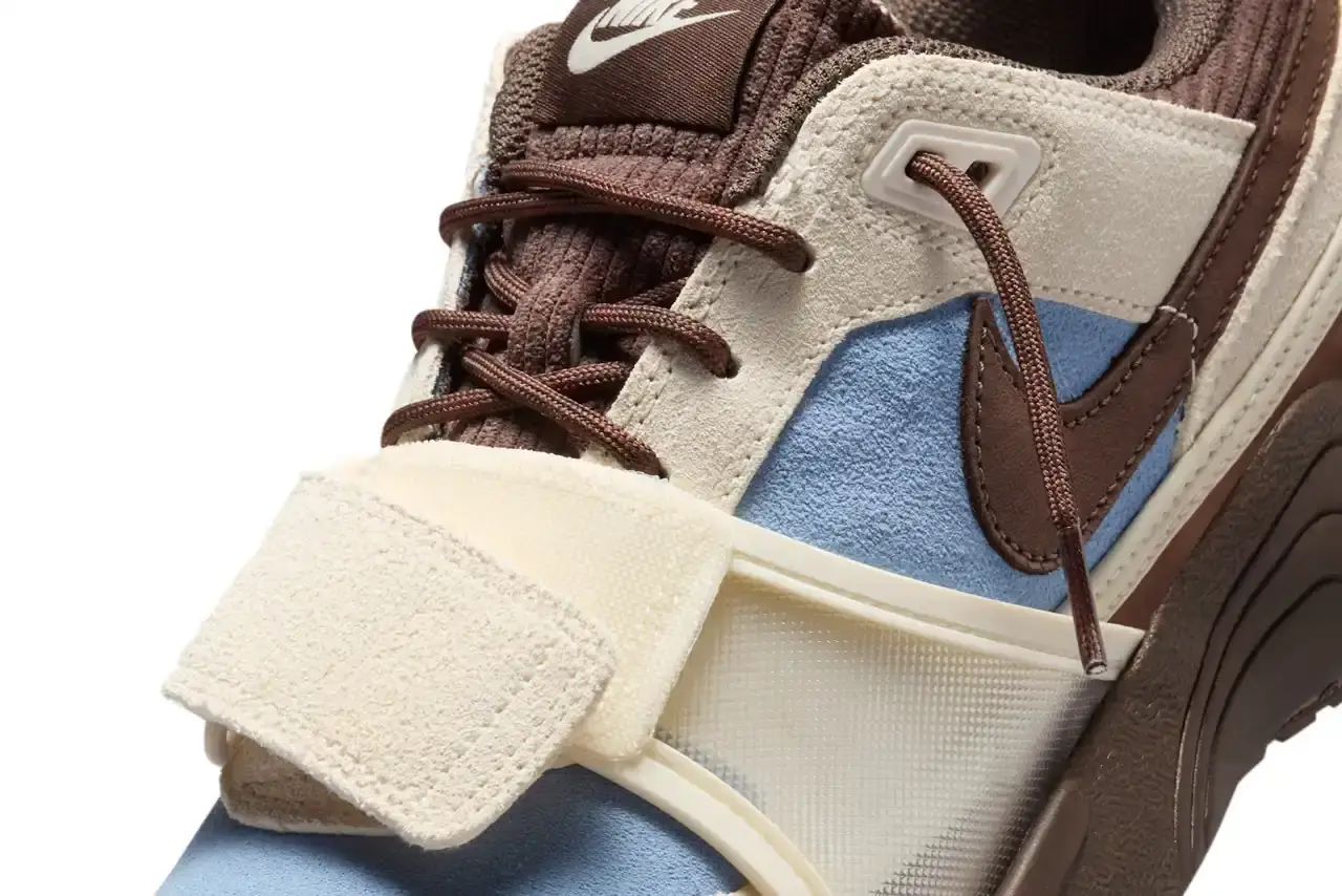 NIKE UNVEILS TRAVIS SCOTT'S ZOOM FIELD JAXX IN "LECHE BLUE" Image of the upcoming release of the Travis Scott x Nike Zoom Field Jaxx sneaker in "Leche Blue" colorway. It details the shoe's design inspiration from the Zoom Spiridon runner and Land Shark baseball cleat, describes the blue and brown color scheme, mentions the $170 price point, and notes the May 16 release date through Nike SNKRS and select retailers. (image 6 of 7)