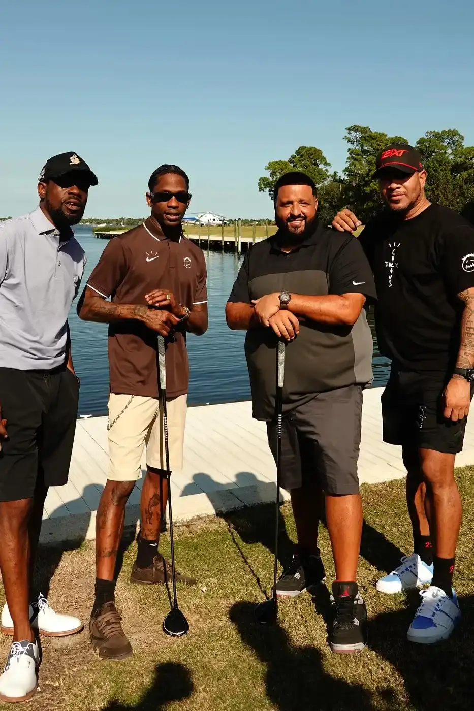 Dj Khaled Travis Scott playing golf wearing a brown Dark Mocha polo with Cactus Jack and Nike logos during Reggie Jackson's Celebrity Golf Classic