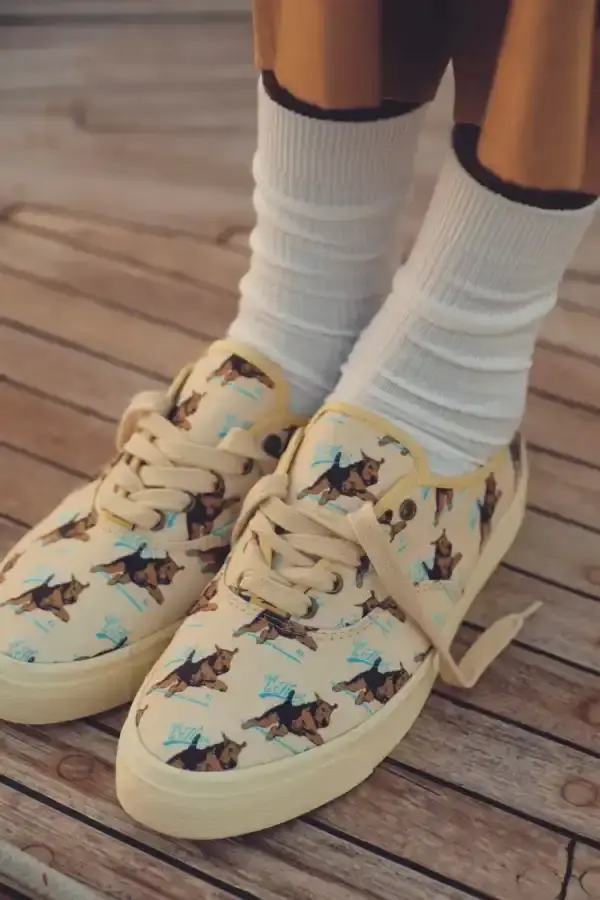 TYLER, THE CREATOR UNVEILS CONVERSE ARCHIVE COLLECTION image of the new collaboration between Tyler, The Creator's GOLF le FLEUR* brand and Converse. The collection, named "1908" after Converse's founding year, features two archive shoe models: the Naut-1 from 1971 and the Coach Jogger from 1976, which was originally an Olympic running shoe. Tyler has redesigned both models with preppy elements, co-branded logos, pastel colors, and in some cases, the signature "Darryl" pattern featuring repeating Airedale Terrier images. This collaboration represents a new direction for their partnership by focusing on previously unused historical designs from Converse's archives. The collection will be available online starting June 20. (image 2 of 6)