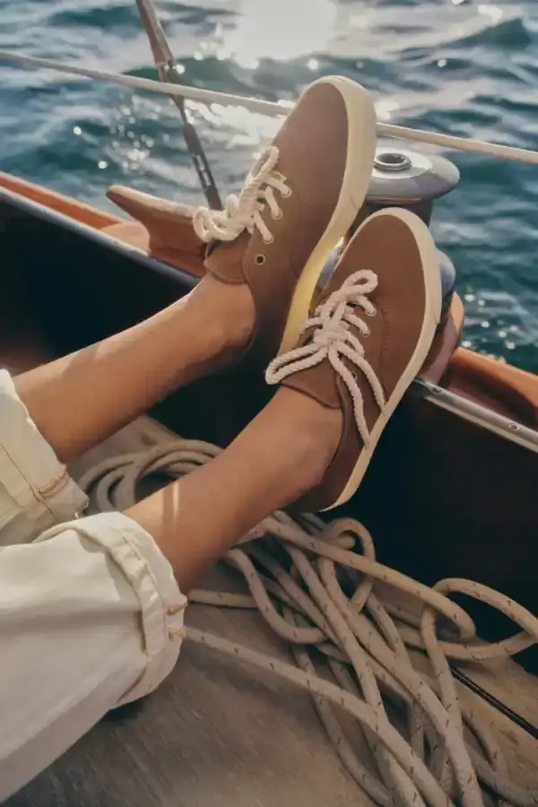 TYLER, THE CREATOR UNVEILS CONVERSE ARCHIVE COLLECTION image of the new collaboration between Tyler, The Creator's GOLF le FLEUR* brand and Converse. The collection, named "1908" after Converse's founding year, features two archive shoe models: the Naut-1 from 1971 and the Coach Jogger from 1976, which was originally an Olympic running shoe. Tyler has redesigned both models with preppy elements, co-branded logos, pastel colors, and in some cases, the signature "Darryl" pattern featuring repeating Airedale Terrier images. This collaboration represents a new direction for their partnership by focusing on previously unused historical designs from Converse's archives. The collection will be available online starting June 20. (image 3 of 6)