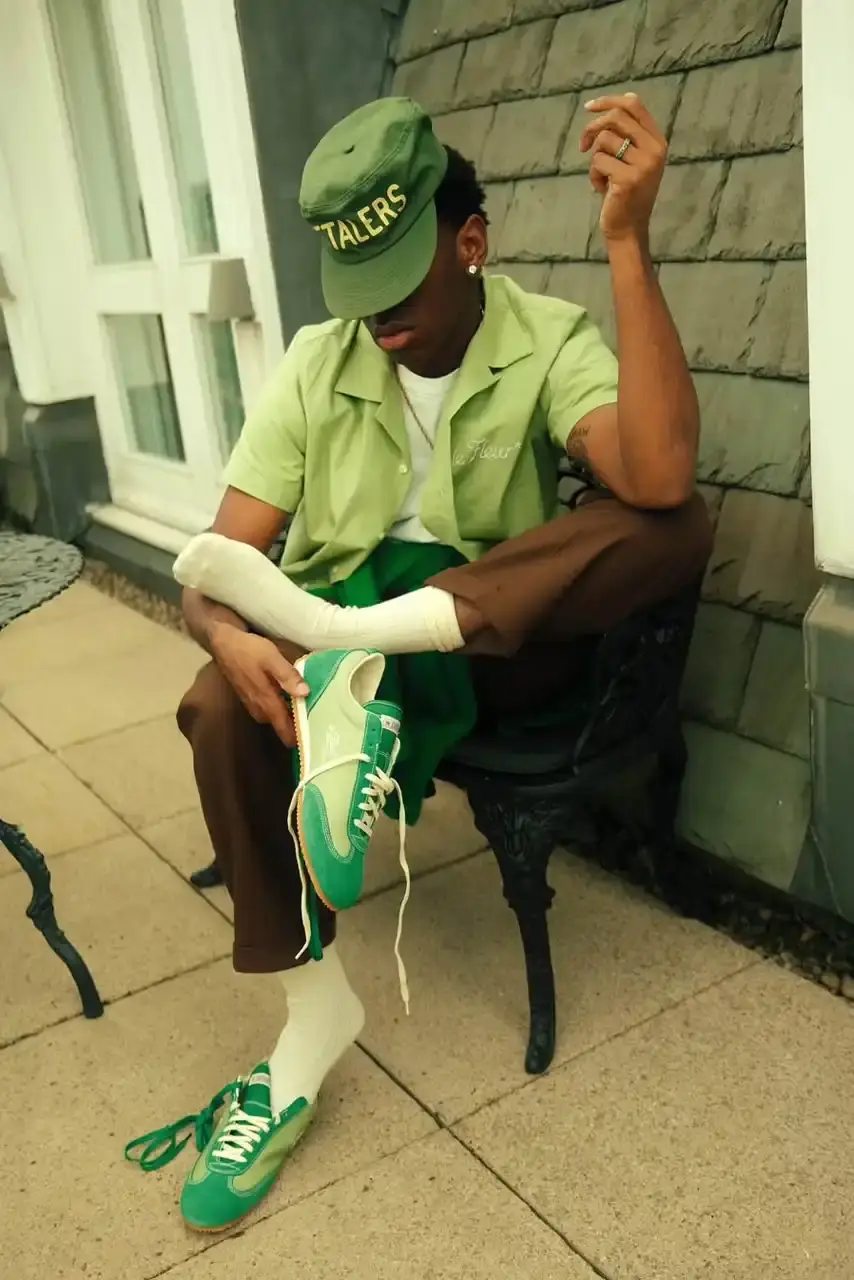 TYLER, THE CREATOR UNVEILS CONVERSE ARCHIVE COLLECTION image of the new collaboration between Tyler, The Creator's GOLF le FLEUR* brand and Converse. The collection, named "1908" after Converse's founding year, features two archive shoe models: the Naut-1 from 1971 and the Coach Jogger from 1976, which was originally an Olympic running shoe. Tyler has redesigned both models with preppy elements, co-branded logos, pastel colors, and in some cases, the signature "Darryl" pattern featuring repeating Airedale Terrier images. This collaboration represents a new direction for their partnership by focusing on previously unused historical designs from Converse's archives. The collection will be available online starting June 20.