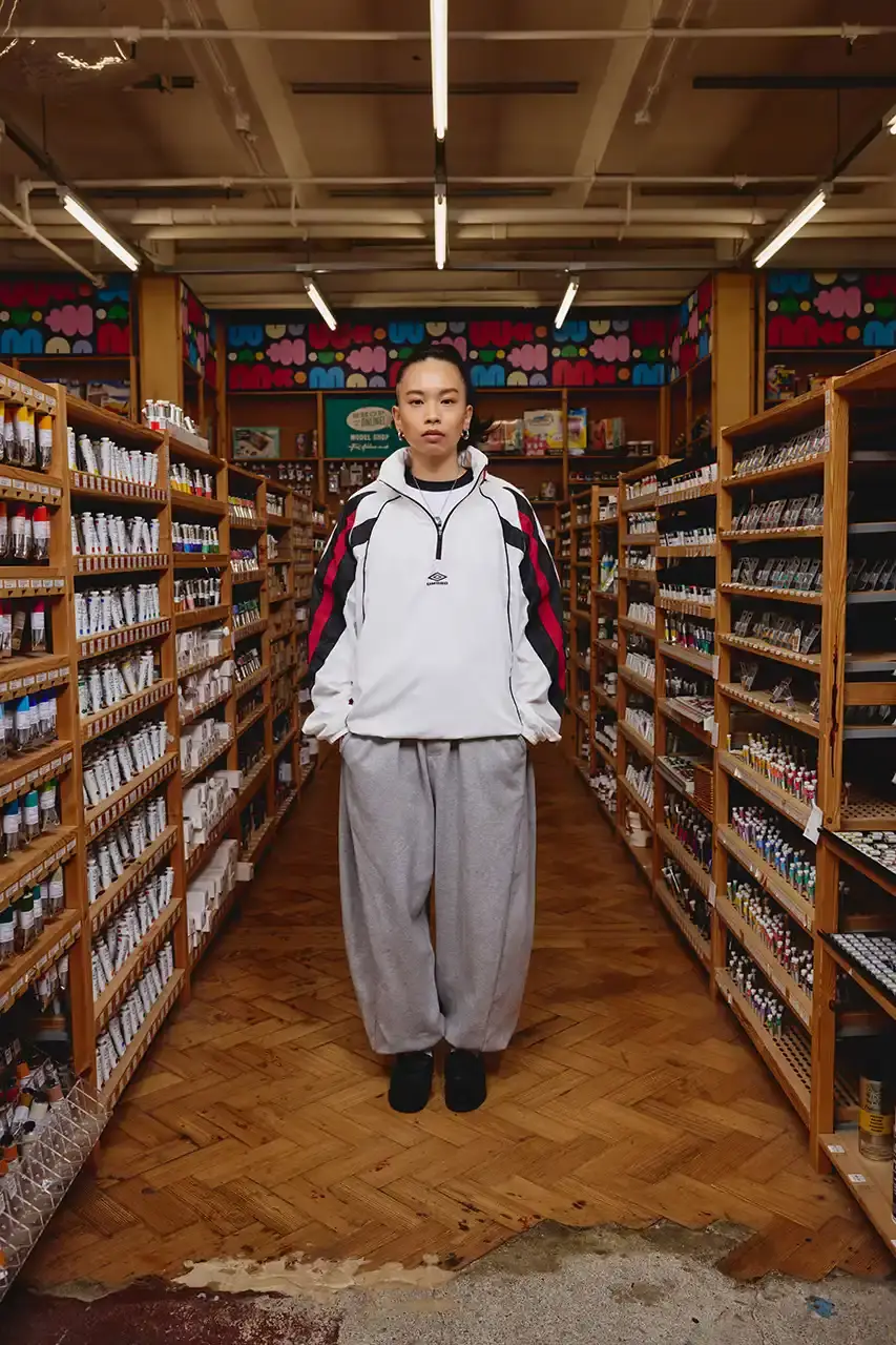 Umbro Umbro SS25 Northern Quarter collection featuring redesigned sportswear classics in white, red, black and charcoal gray, including the Zip Off Sleeve Wind Jacket and '90s-inspired Washed Drill pieces that blend Manchester heritage with contemporary design. (image 4 of 15)