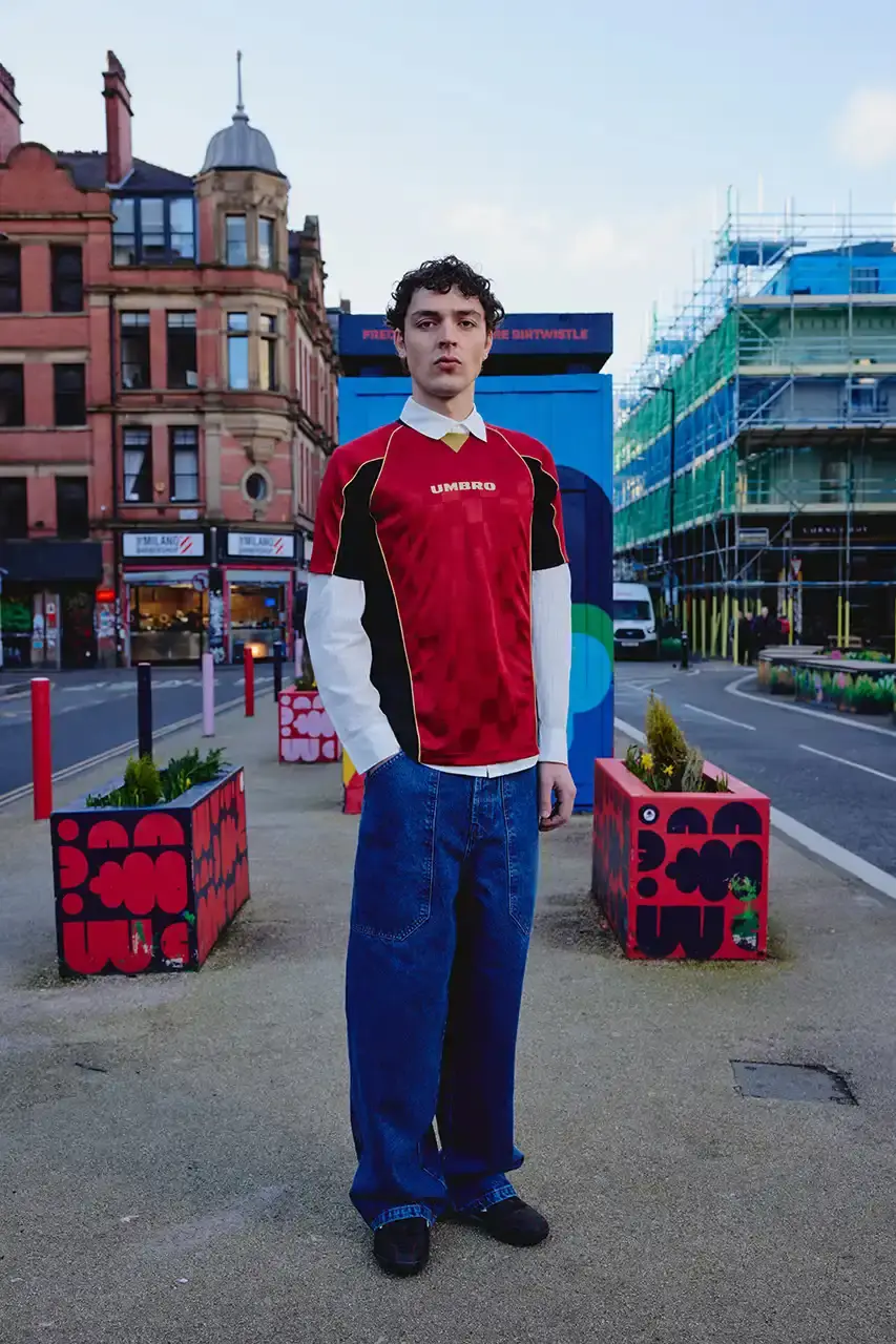 Umbro Umbro SS25 Northern Quarter collection featuring redesigned sportswear classics in white, red, black and charcoal gray, including the Zip Off Sleeve Wind Jacket and '90s-inspired Washed Drill pieces that blend Manchester heritage with contemporary design. (image 12 of 15)