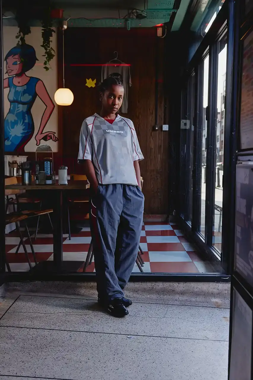 Umbro Umbro SS25 Northern Quarter collection featuring redesigned sportswear classics in white, red, black and charcoal gray, including the Zip Off Sleeve Wind Jacket and '90s-inspired Washed Drill pieces that blend Manchester heritage with contemporary design. (image 15 of 15)
