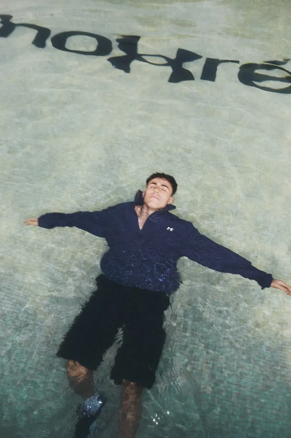 UNDER ARMOUR REST LESS OFF-SEASON CAMPAIGN image of Under Armour Rest Less campaign featuring athletes and creators at the fictional Hotel Armouré wearing Fall Winter 2026 sportswear. (image 2 of 5)
