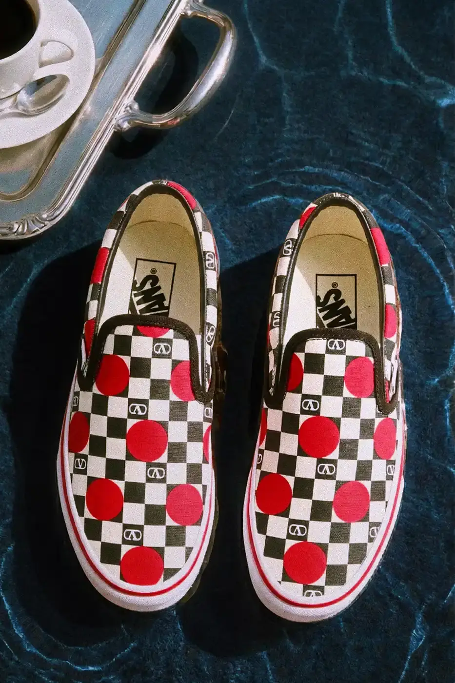 VALENTINO AND VANS RELEASE NEW SLIP-ON COLLECTION Valentino and Vans collaborate on six Classic Slip-On sneaker styles with signature VLogo patterns, checkerboard designs, and tropical prints, priced at $490 USD. (image 4 of 7)