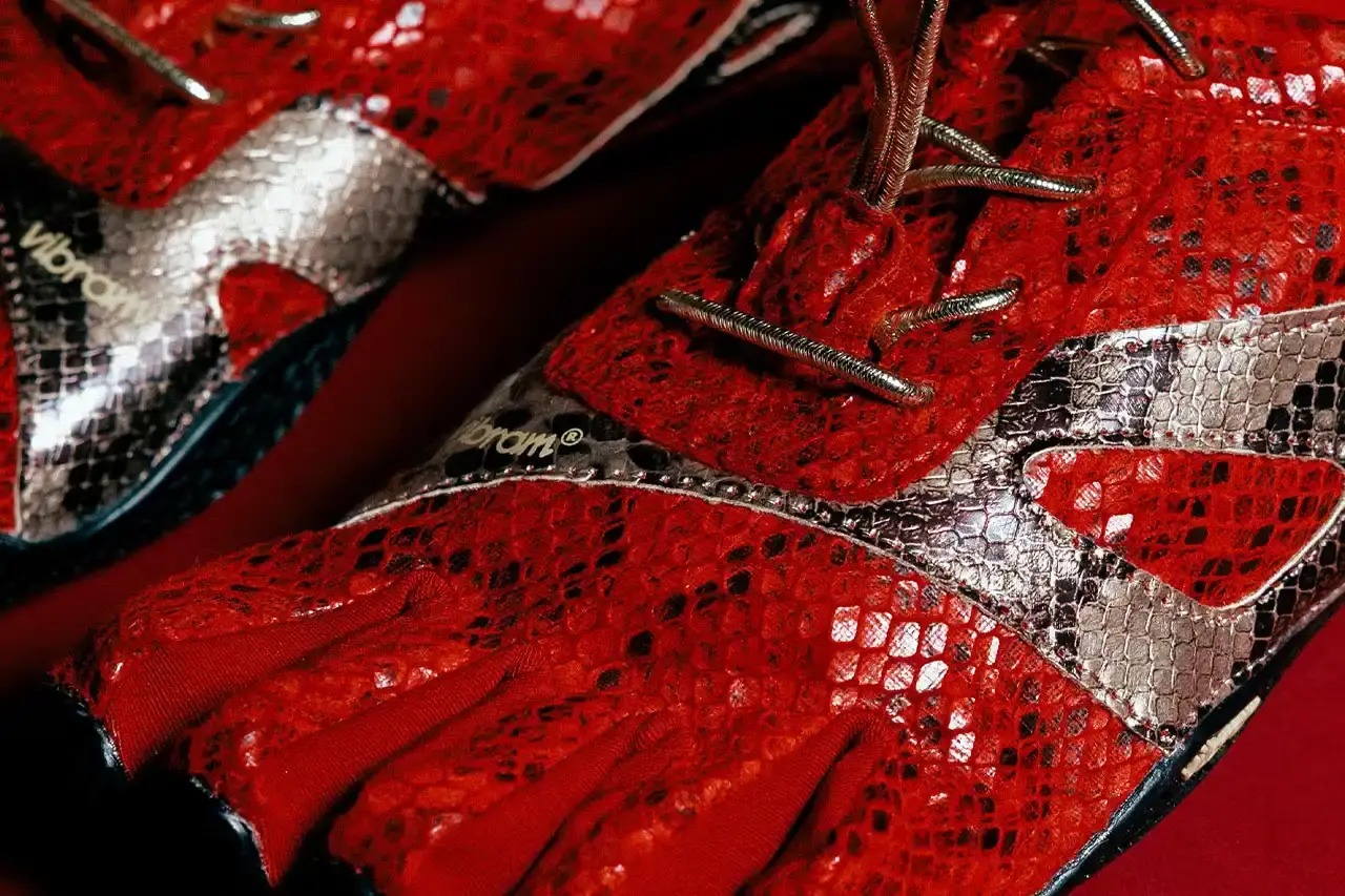 Vibram Vibram KSO Evo minimalist toe shoe in bright red with snakeskin-textured upper pattern. The shoe has individual toe pockets and a thin, flexible sole typical of FiveFingers footwear design. Viewed from a side angle showing the distinctive snake scale pattern across the mesh material. (image 10 of 10)
