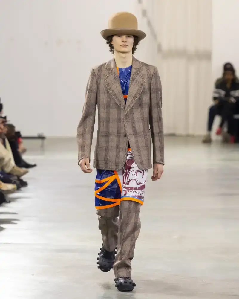 WALTER VAN BEIRENDONCK'S FALL/WINTER 2026 Belgian designer Walter Van Beirendonck presents his Fall/Winter 2026-2027 collection SCARE the CROW / SCARECROW, drawing from Art Brut influences and examining contemporary youth culture through contrasting elements of aggression and tenderness. (image 46 of 51)