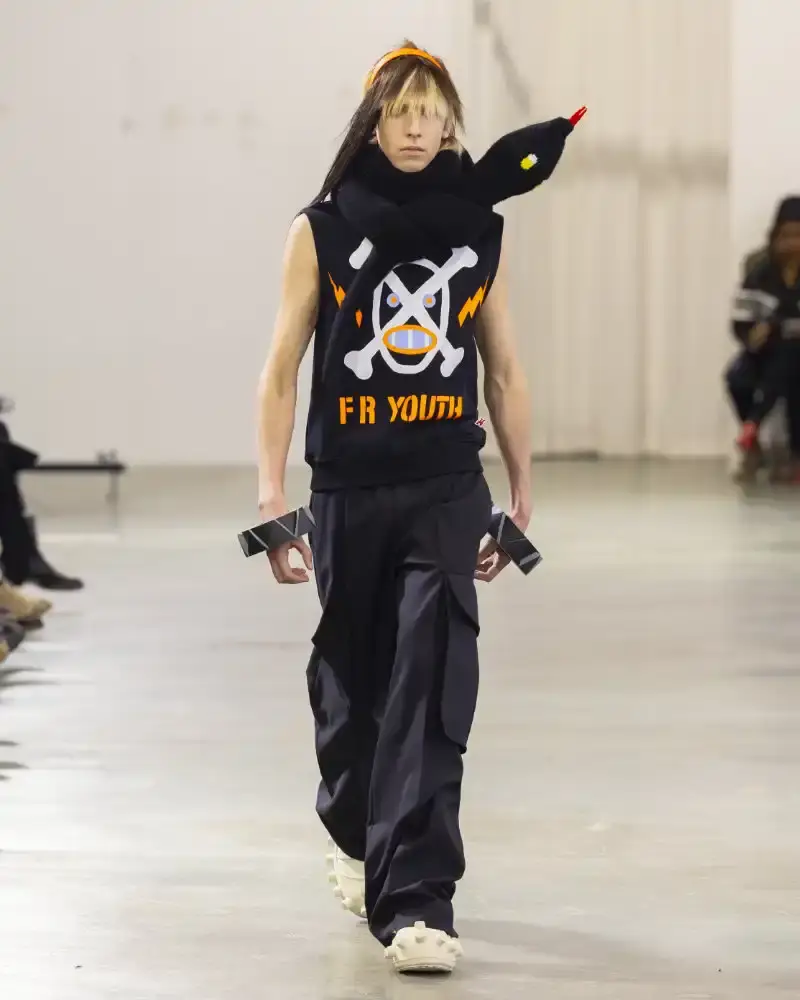 WALTER VAN BEIRENDONCK'S FALL/WINTER 2026 Belgian designer Walter Van Beirendonck presents his Fall/Winter 2026-2027 collection SCARE the CROW / SCARECROW, drawing from Art Brut influences and examining contemporary youth culture through contrasting elements of aggression and tenderness. (image 16 of 51)