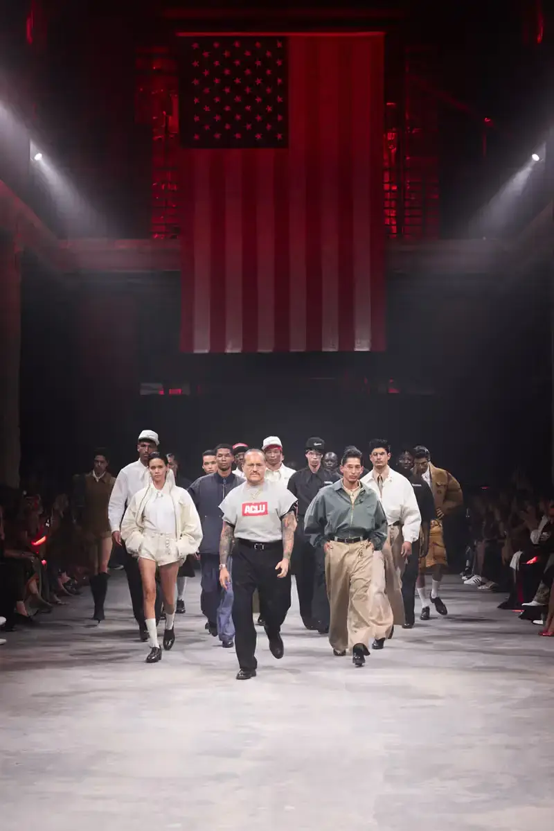 WILLY CHAVARRIA SS25: A SARTORIAL ODE TO THE AMERICAN DREAM Willy Chavarria leading a diverse group of 68 models for the final runway walk, showcasing the full range of his 'América' collection