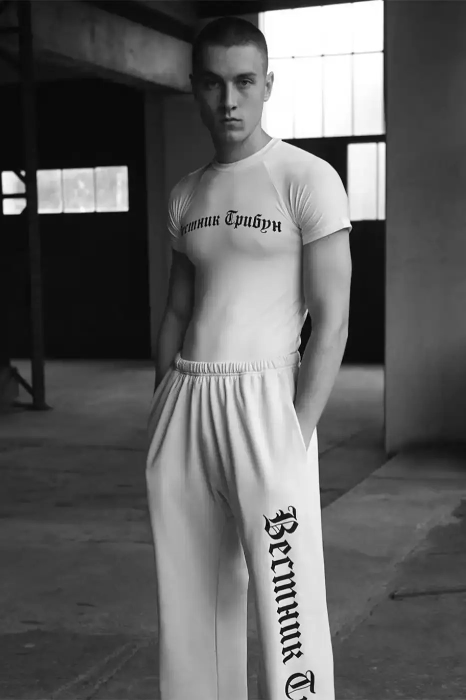 YZY Article about YZY's new collection designed by Gosha Rubchinskiy, highlighting a nine-piece monochromatic line with Cyrillic text elements inspired by The New York Herald Tribune and Jean-Luc Godard's Breathless film.