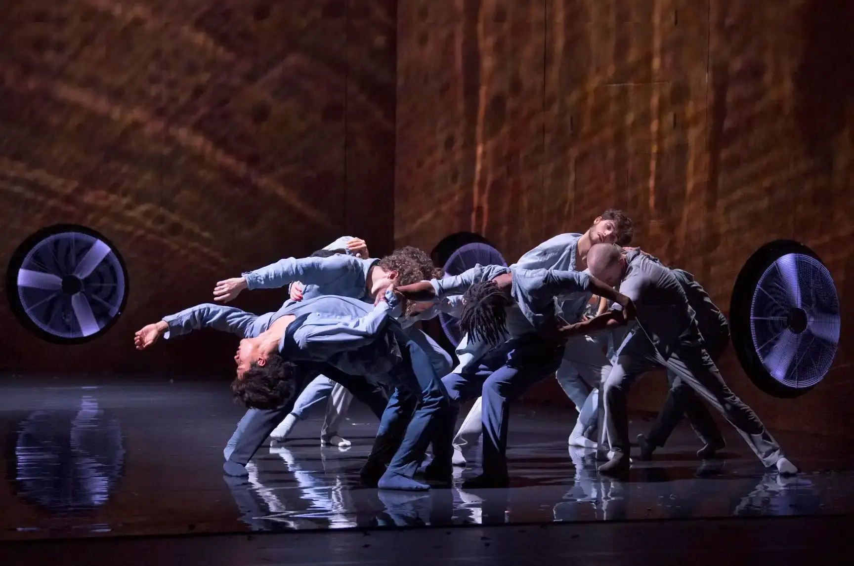 ZÉPHYR: MOURAD MERZOUKI MAKES THE WIND MOVE Dancers in Zephyr by Mourad Merzouki leaning into resistance on stage at 13eme Art Paris